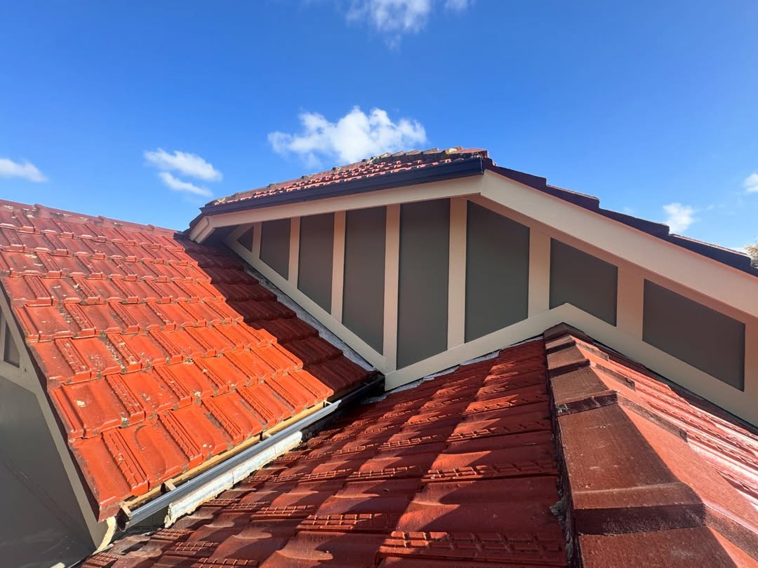 Detailed dormer and trim painting on heritage roof
