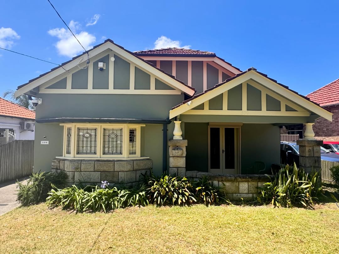 Heritage bungalow exterior painting with green and cream colour scheme