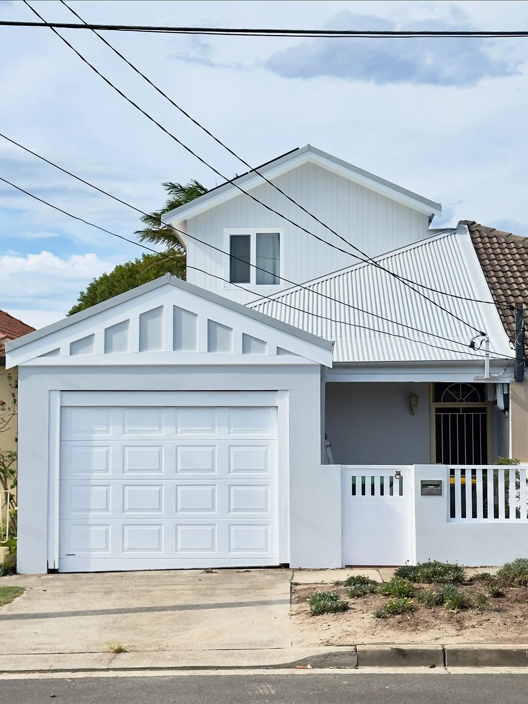White weatherboard home exterior painting with grey accents