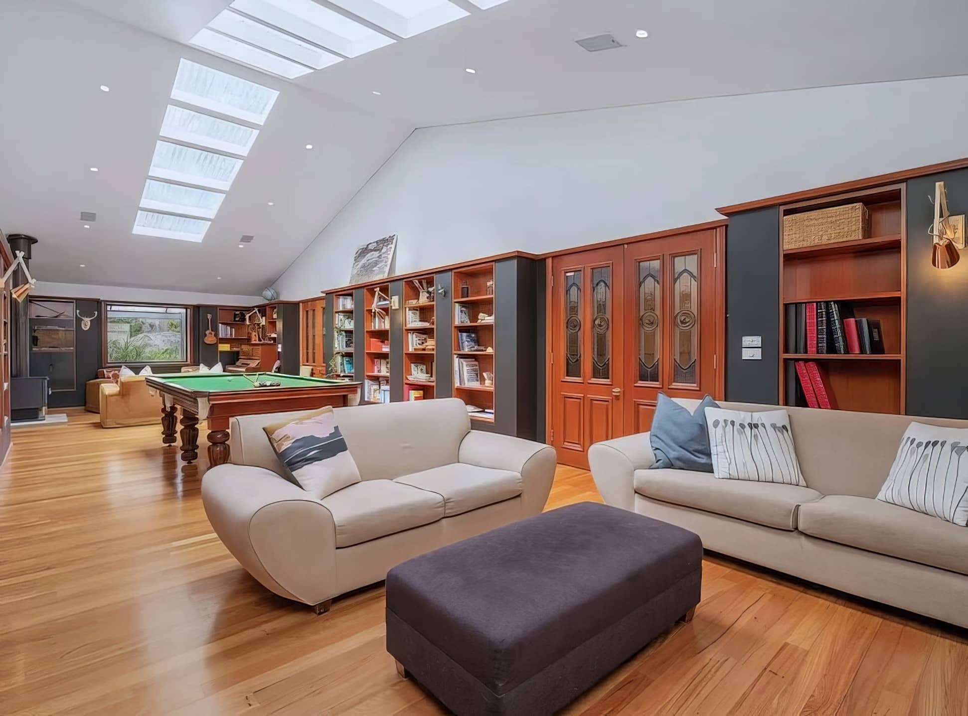Spacious living room with freshly painted walls, skylights and timber features