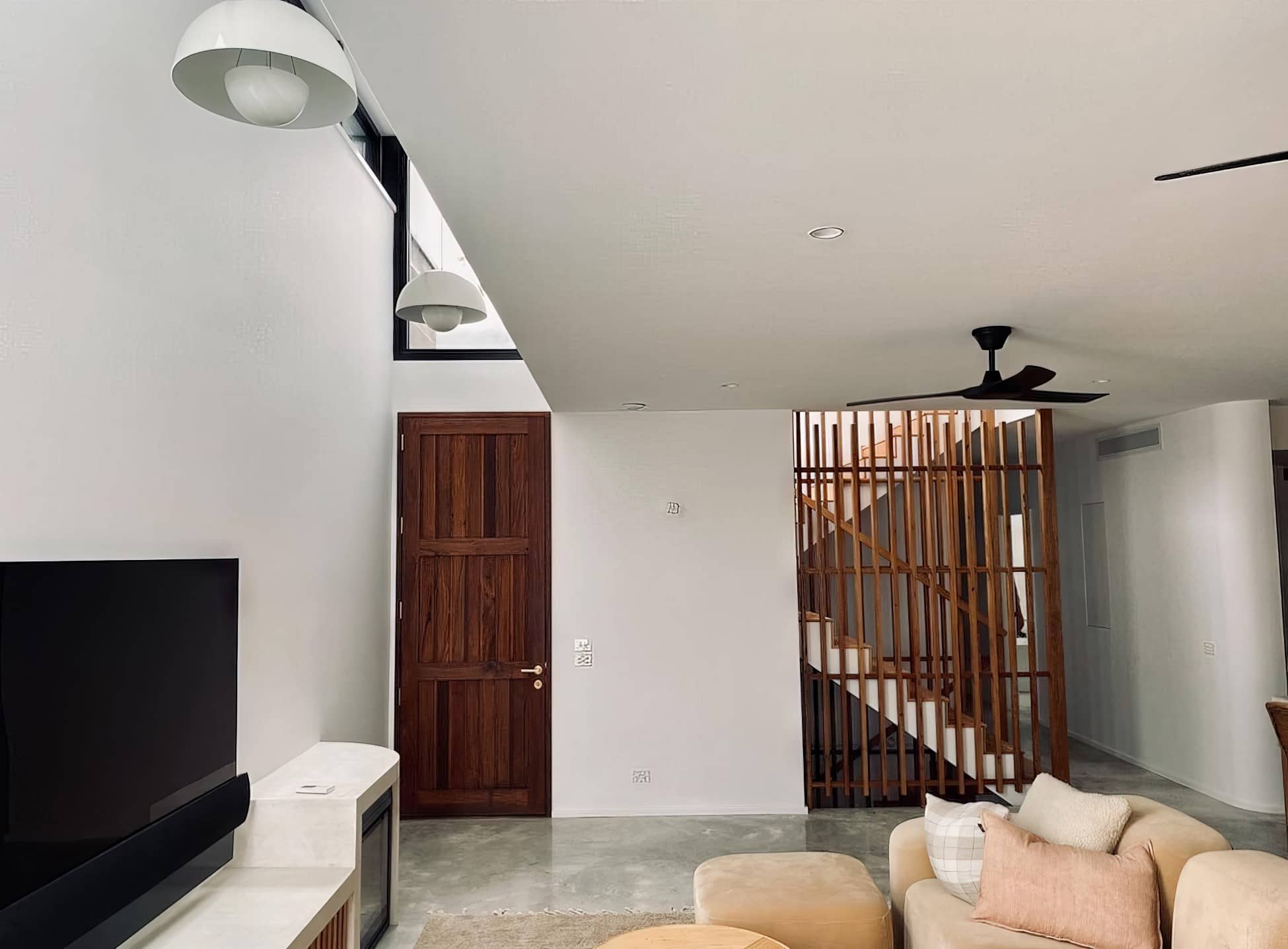 Living area painting with white walls and timber staircase